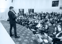 Corporate keynote speaker engaging a B2B audience at a branded event by Plan and Pivot Events