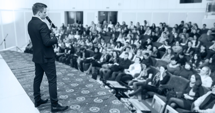 Corporate keynote speaker engaging a B2B audience at a branded event by Plan and Pivot Events